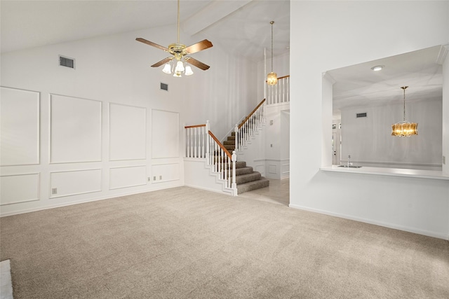 4423 Nassau Dr, Sugar Land, TX 77479 - unfurnished living room featuring visible vents, stairs, high vaulted ceiling, carpet flooring, and ceiling fan with notable chandelier