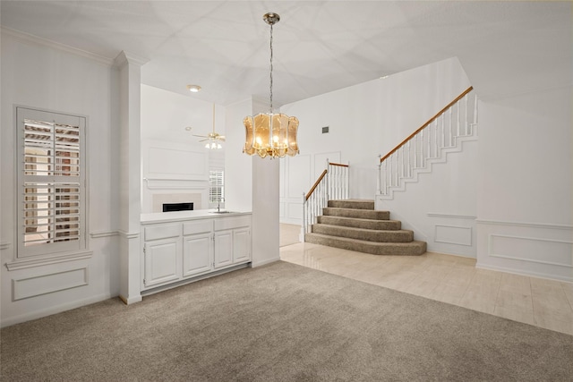 4423 Nassau Dr, Sugar Land, TX 77479 - interior space featuring stairway, a decorative wall, carpet flooring, and a notable chandelier