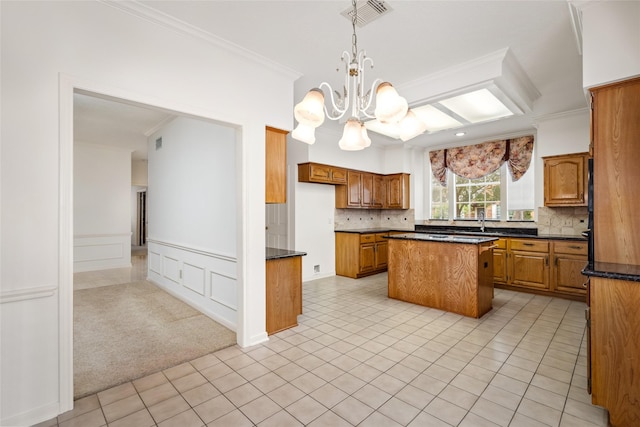 4423 Nassau Dr, Sugar Land, TX 77479 - kitchen with crown molding, brown cabinets, and visible vents