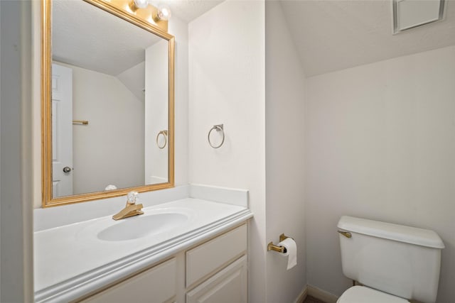 4423 Nassau Dr, Sugar Land, TX 77479 - half bath featuring vanity, a textured ceiling, vaulted ceiling, and toilet