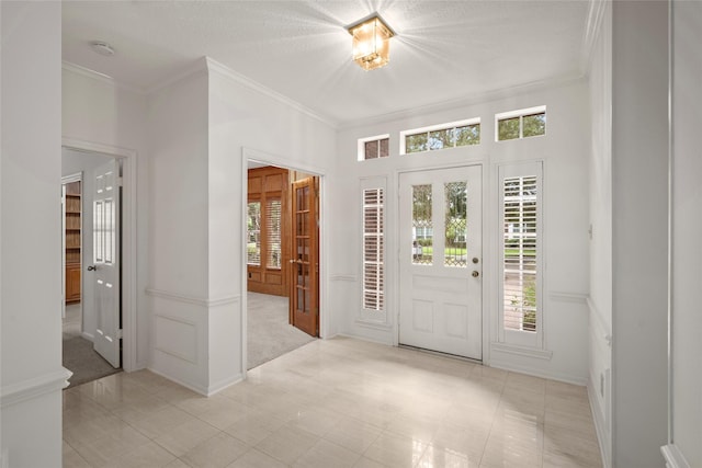 4423 Nassau Dr, Sugar Land, TX 77479 - carpeted foyer featuring ornamental molding, tile patterned floors, and a healthy amount of sunlight