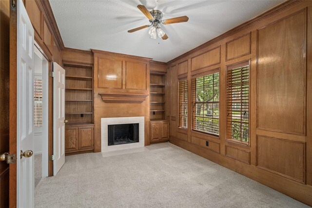 4423 Nassau Dr, Sugar Land, TX 77479 - unfurnished living room featuring light colored carpet, built in features, and crown molding