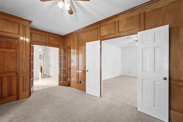 4423 Nassau Dr, Sugar Land, TX 77479 - spare room featuring light colored carpet, a ceiling fan, and wooden walls