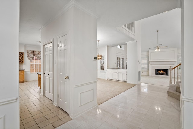4423 Nassau Dr, Sugar Land, TX 77479 - hallway featuring baseboards, ornamental molding, light tile patterned flooring, and light carpet