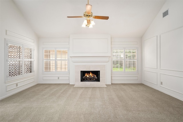 4423 Nassau Dr, Sugar Land, TX 77479 - unfurnished living room featuring ceiling fan, a tiled fireplace, carpet, lofted ceiling, and visible vents