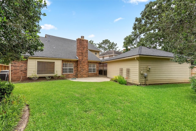 4423 Nassau Dr, Sugar Land, TX 77479 - back of property featuring a patio, a lawn, fence, and a chimney