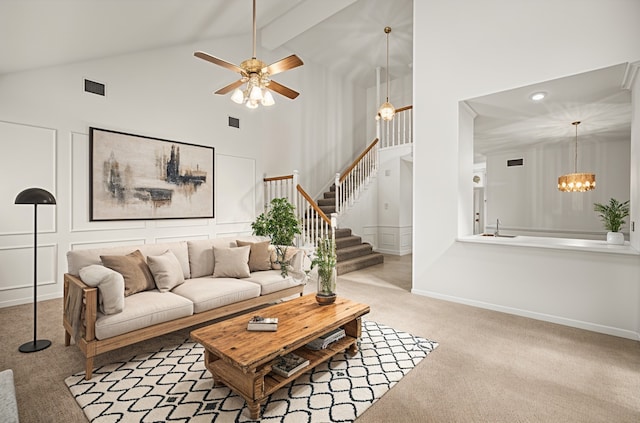 4423 Nassau Dr, Sugar Land, TX 77479 - carpeted living area with a sink, high vaulted ceiling, ceiling fan with notable chandelier, visible vents, and stairway