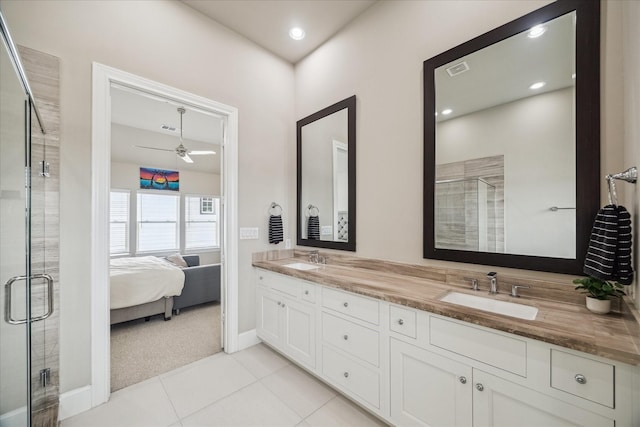 bathroom with double vanity, a ceiling fan, a sink, and a stall shower