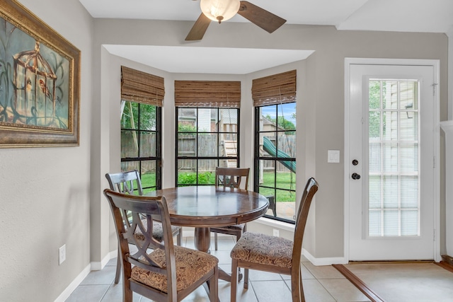 dining room with baseboards, ceiling fan, and light tile patterned floors