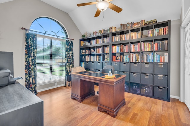 office featuring baseboards, ceiling fan, vaulted ceiling, and wood finished floors