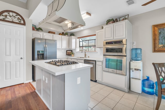 kitchen with visible vents, light countertops, white cabinetry, and stainless steel appliances