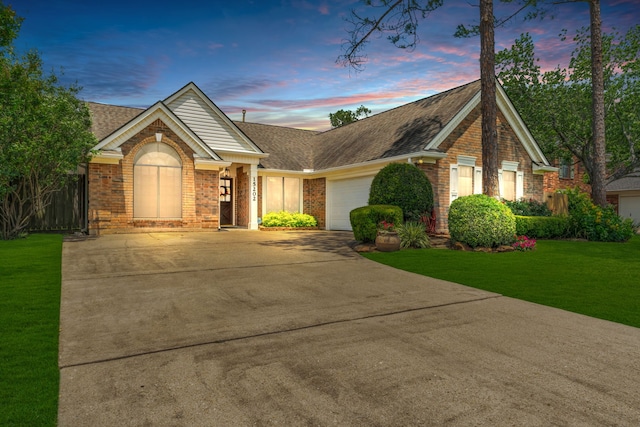 single story home featuring roof with shingles, concrete driveway, and brick siding