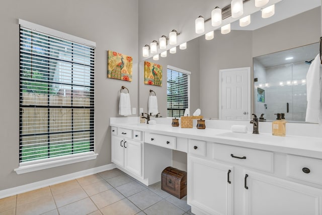 full bathroom with tile patterned flooring, a sink, baseboards, and a healthy amount of sunlight