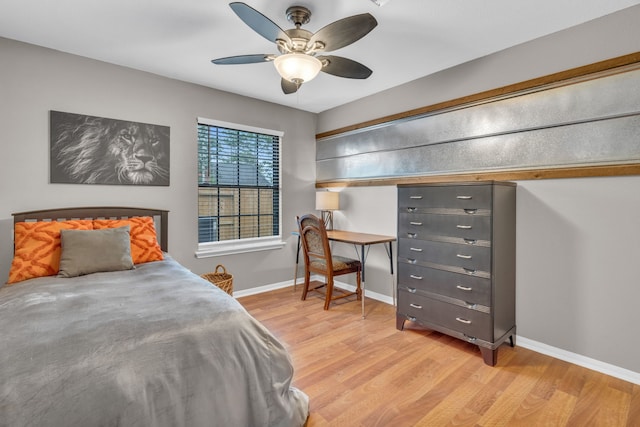 bedroom featuring baseboards, ceiling fan, and light wood-style floors
