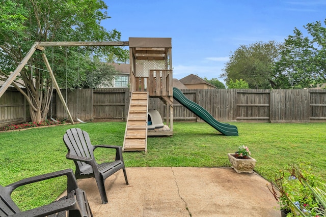 view of jungle gym with a yard, a patio, and a fenced backyard