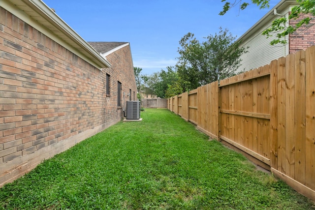view of yard featuring a fenced backyard and central AC unit