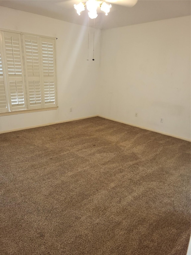carpeted empty room with baseboards
