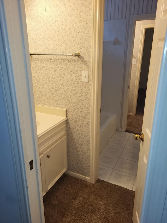 bathroom with vanity, tile patterned flooring, a washtub, and wallpapered walls
