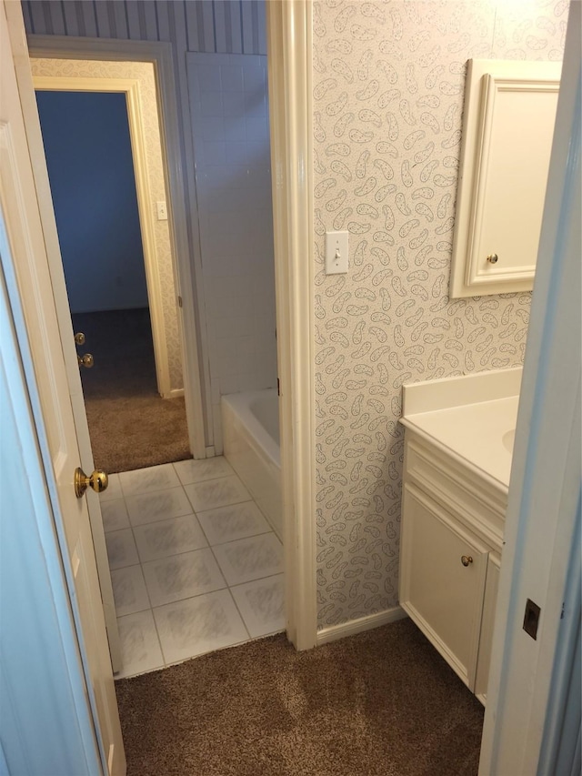 full bathroom featuring vanity, tile patterned floors, wallpapered walls, and a bathtub
