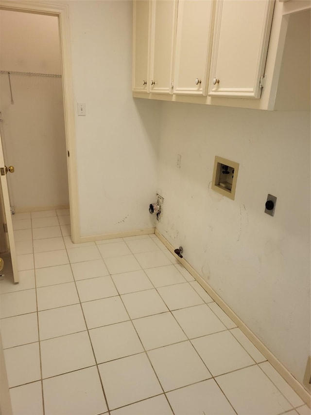 clothes washing area with washer hookup, electric dryer hookup, hookup for a gas dryer, cabinet space, and baseboards