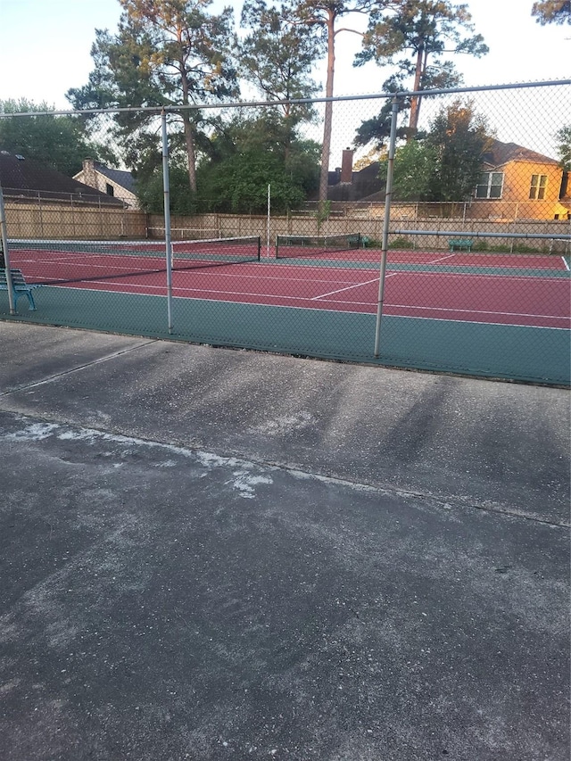 view of tennis court with fence