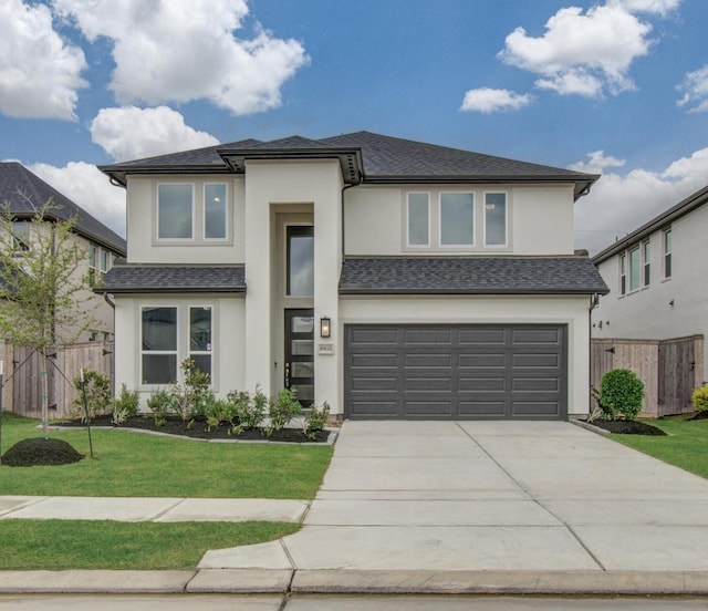 8815 Drysdale River Rd, Cypress, TX 77433 - prairie-style house featuring fence, stucco siding, an attached garage, and driveway