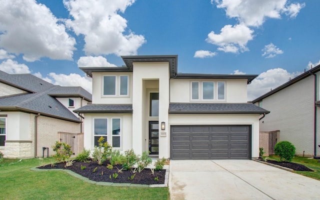 8815 Drysdale River Rd, Cypress, TX 77433 - prairie-style home featuring driveway, a front yard, a garage, fence, and stucco siding