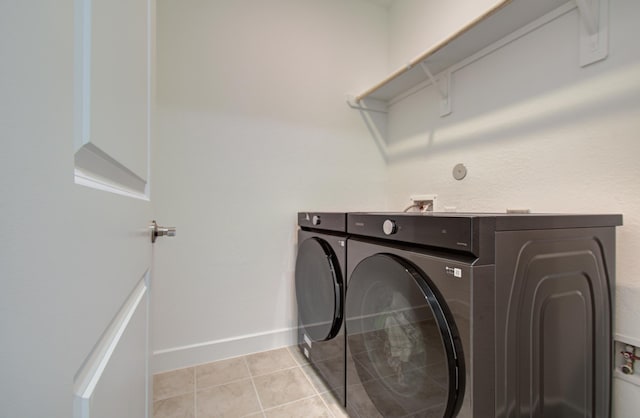 8815 Drysdale River Rd, Cypress, TX 77433 - clothes washing area featuring light tile patterned floors, baseboards, laundry area, and washing machine and dryer