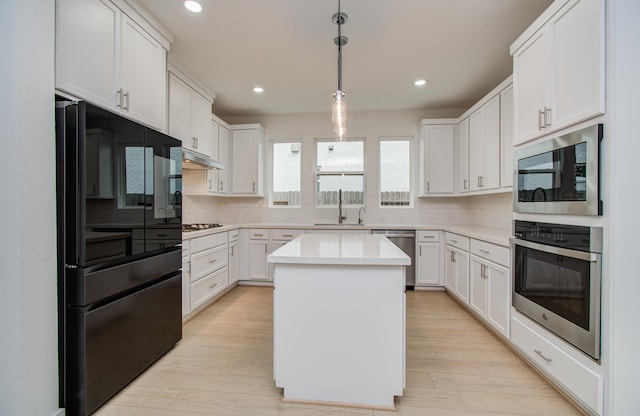 8815 Drysdale River Rd, Cypress, TX 77433 - kitchen featuring light countertops, stainless steel appliances, decorative backsplash, and a sink