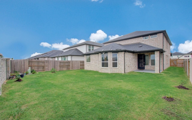 8815 Drysdale River Rd, Cypress, TX 77433 - rear view of property with a fenced backyard, a yard, a patio area, and brick siding