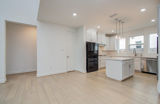 8815 Drysdale River Rd, Cypress, TX 77433 - kitchen featuring visible vents, stainless steel appliances, tasteful backsplash, a sink, and under cabinet range hood