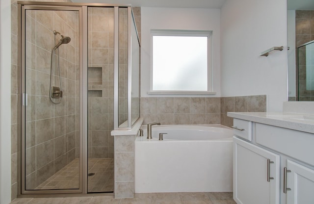 8815 Drysdale River Rd, Cypress, TX 77433 - bathroom with vanity, a garden tub, and a stall shower
