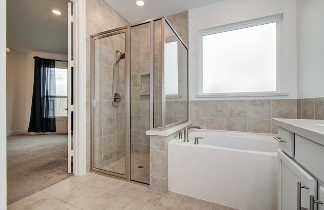 8815 Drysdale River Rd, Cypress, TX 77433 - bathroom featuring tile patterned flooring, vanity, recessed lighting, a bath, and a shower stall