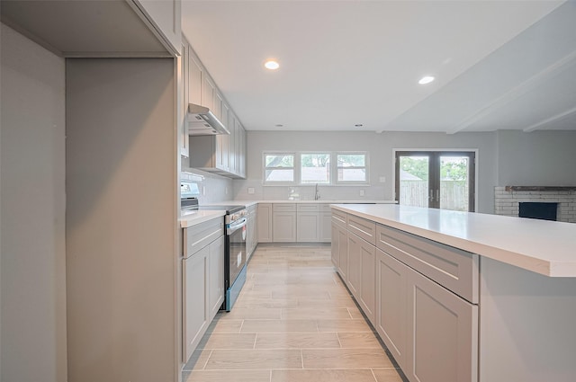 4011 Cypressdale Dr, Spring, TX 77388 - kitchen featuring stainless steel range with electric cooktop, under cabinet range hood, light countertops, recessed lighting, and backsplash