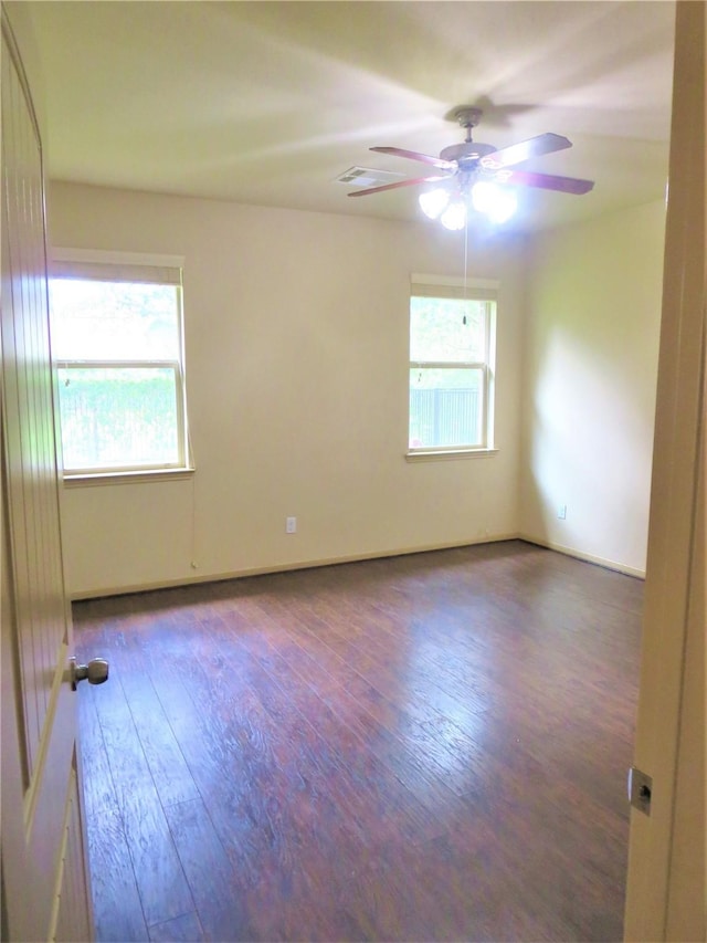 unfurnished room featuring visible vents, ceiling fan, and hardwood / wood-style floors