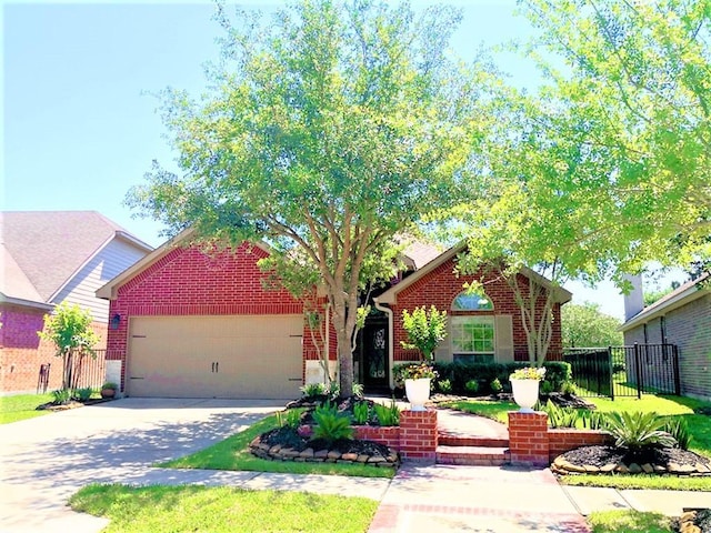 view of front of property featuring brick siding, fence, driveway, and a garage