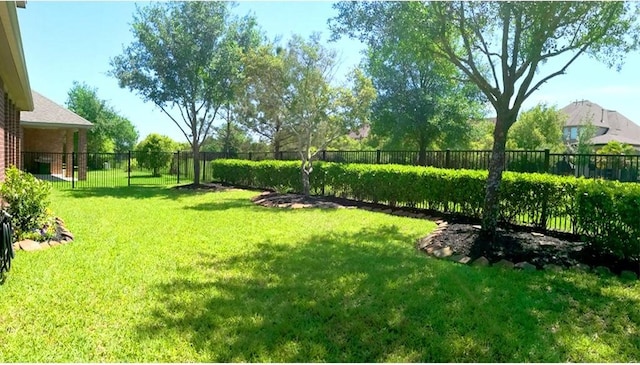 view of yard with a fenced backyard