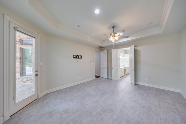 unfurnished bedroom featuring crown molding, access to outside, a tray ceiling, and visible vents