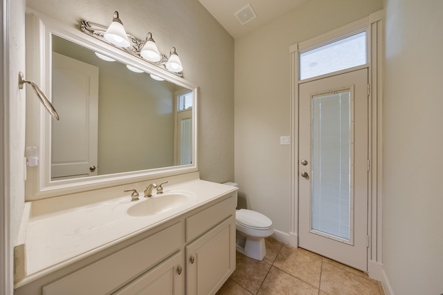 bathroom with tile patterned flooring, visible vents, toilet, and vanity