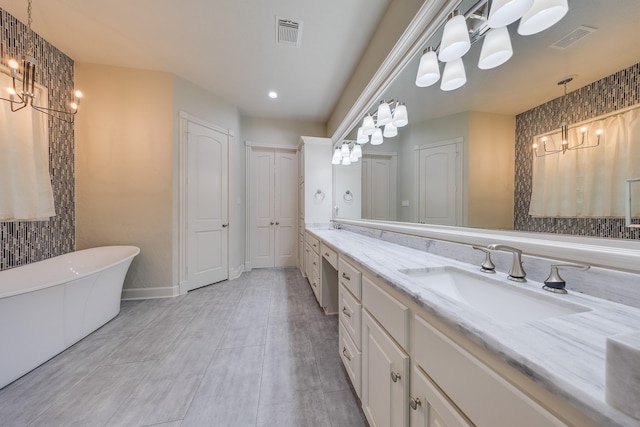 bathroom featuring an inviting chandelier, double vanity, a sink, and visible vents
