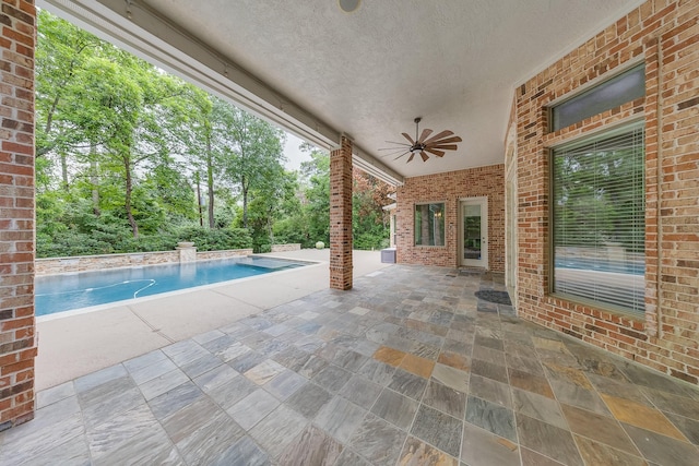 view of patio featuring ceiling fan and an outdoor pool