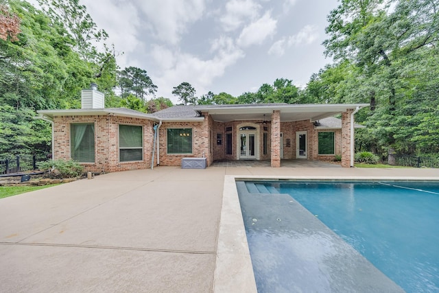 view of swimming pool featuring french doors, a fenced in pool, a patio, and fence