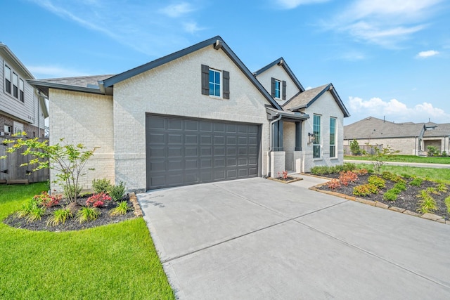 view of front of house featuring fence, concrete driveway, a front yard, and brick siding