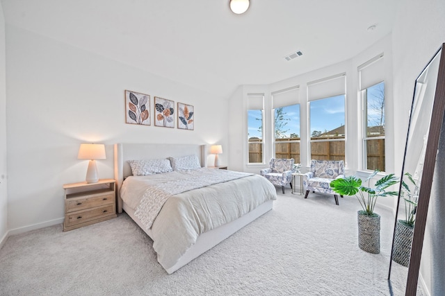 bedroom featuring baseboards, carpet flooring, and visible vents