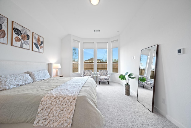 bedroom with carpet floors, baseboards, and visible vents