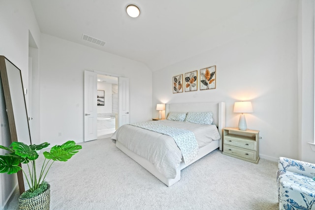 carpeted bedroom featuring baseboards, lofted ceiling, connected bathroom, and visible vents