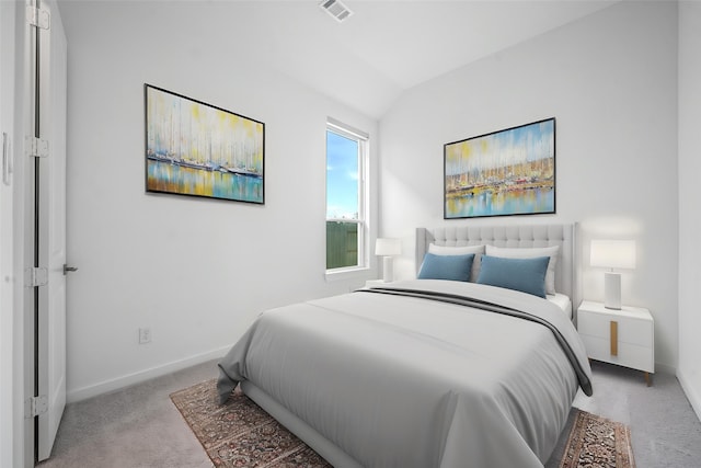 carpeted bedroom with baseboards, lofted ceiling, and visible vents