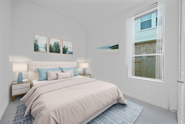 bedroom featuring carpet floors, baseboards, and vaulted ceiling