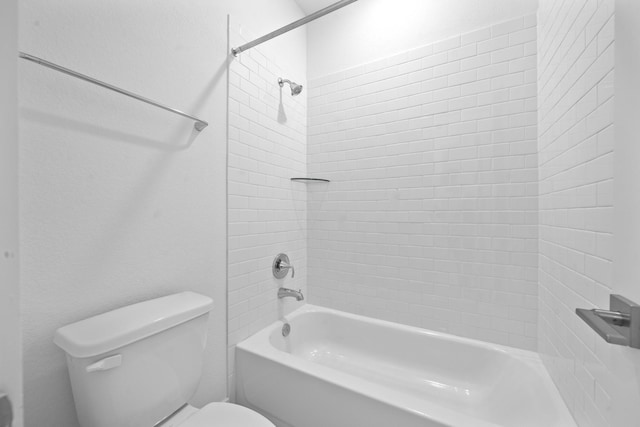 bathroom with shower / bathing tub combination and toilet