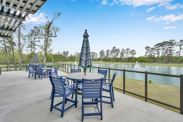 view of patio / terrace with outdoor dining area and a water view